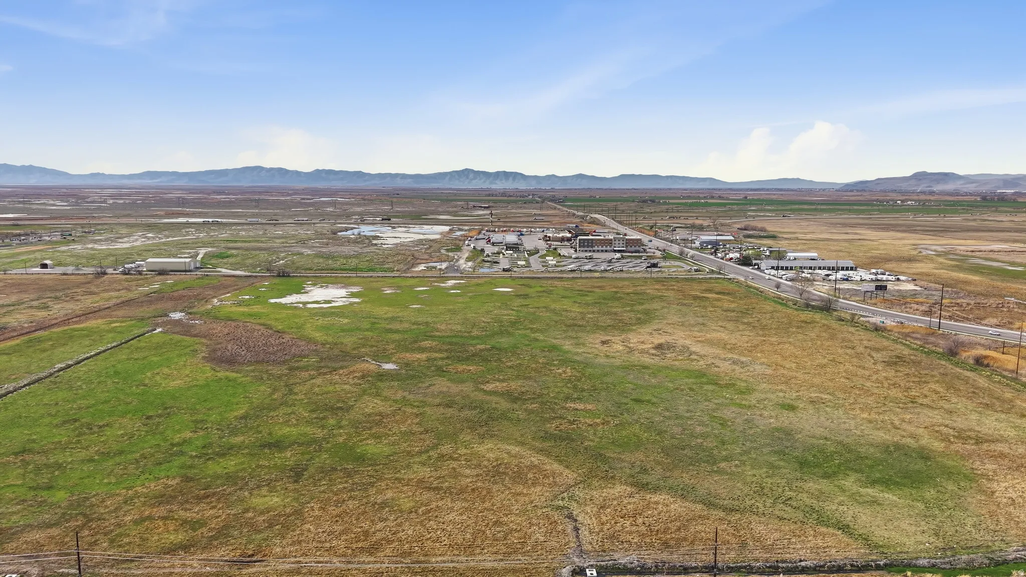 Overview of rural landscape with a mountainous background and nearby suburban area