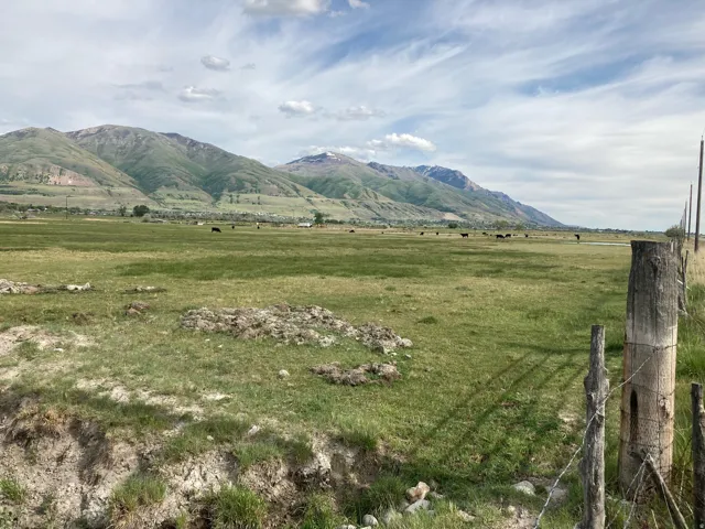 View of mountain backdrop with rural landscape