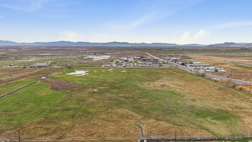 Overview of rural landscape with a mountainous background and nearby suburban area