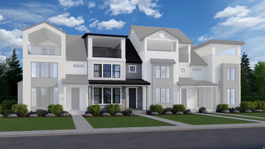 View of front of home featuring a front lawn, a balcony, and stone siding