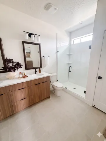 Contemporary bathroom featuring a spacious walk-in shower with clear glass enclosure and built-in shelving