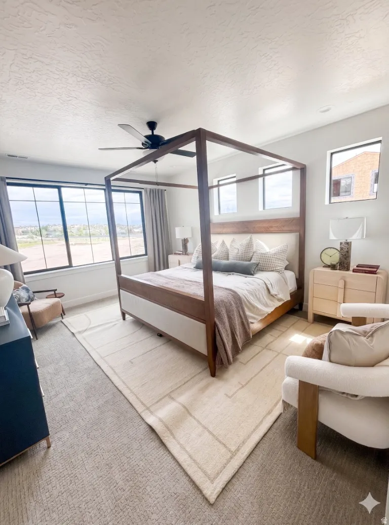 Spacious room featuring multiple windows, a ceiling fan, and carpeted flooring
