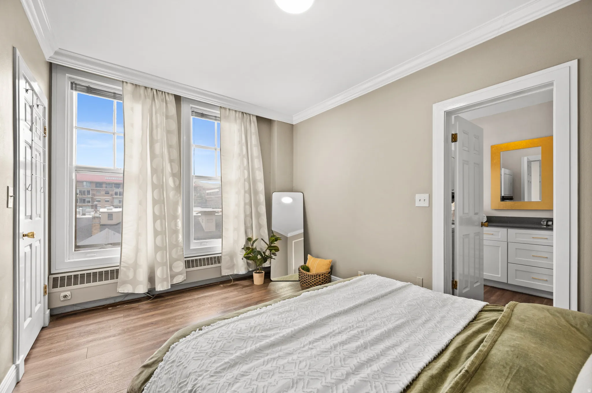 Bedroom featuring ornamental molding and dark wood-style flooring