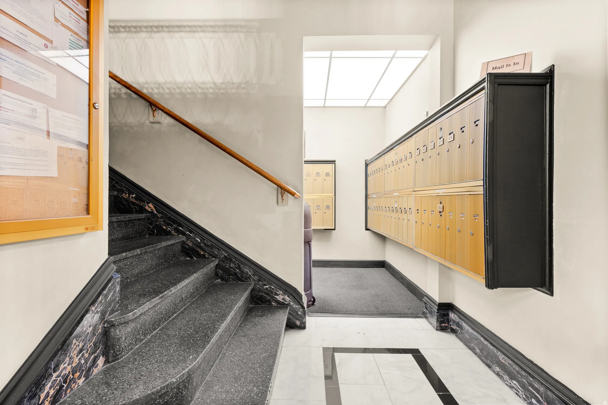 Stairway featuring mail area and inlaid floor details