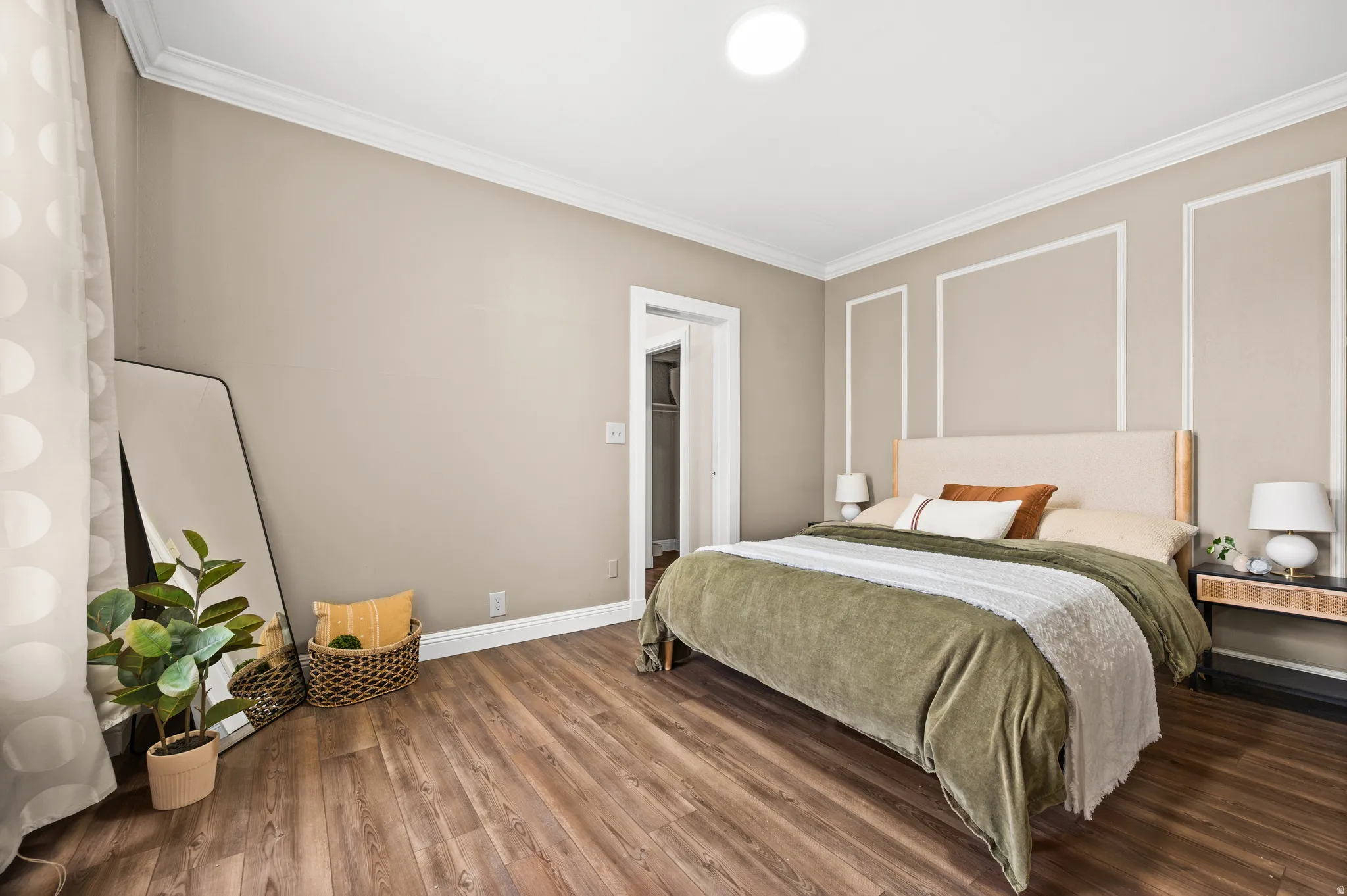 Bedroom featuring crown molding and wood finished floors