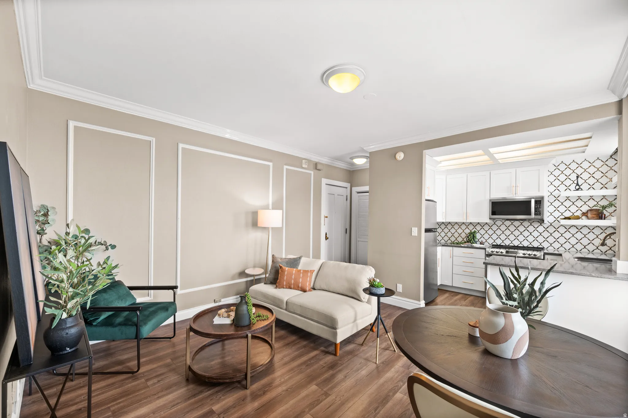 Living room featuring dark wood-type flooring and ornamental molding