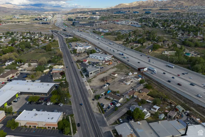 Aerial view of property and surrounding area with a highway and mountains