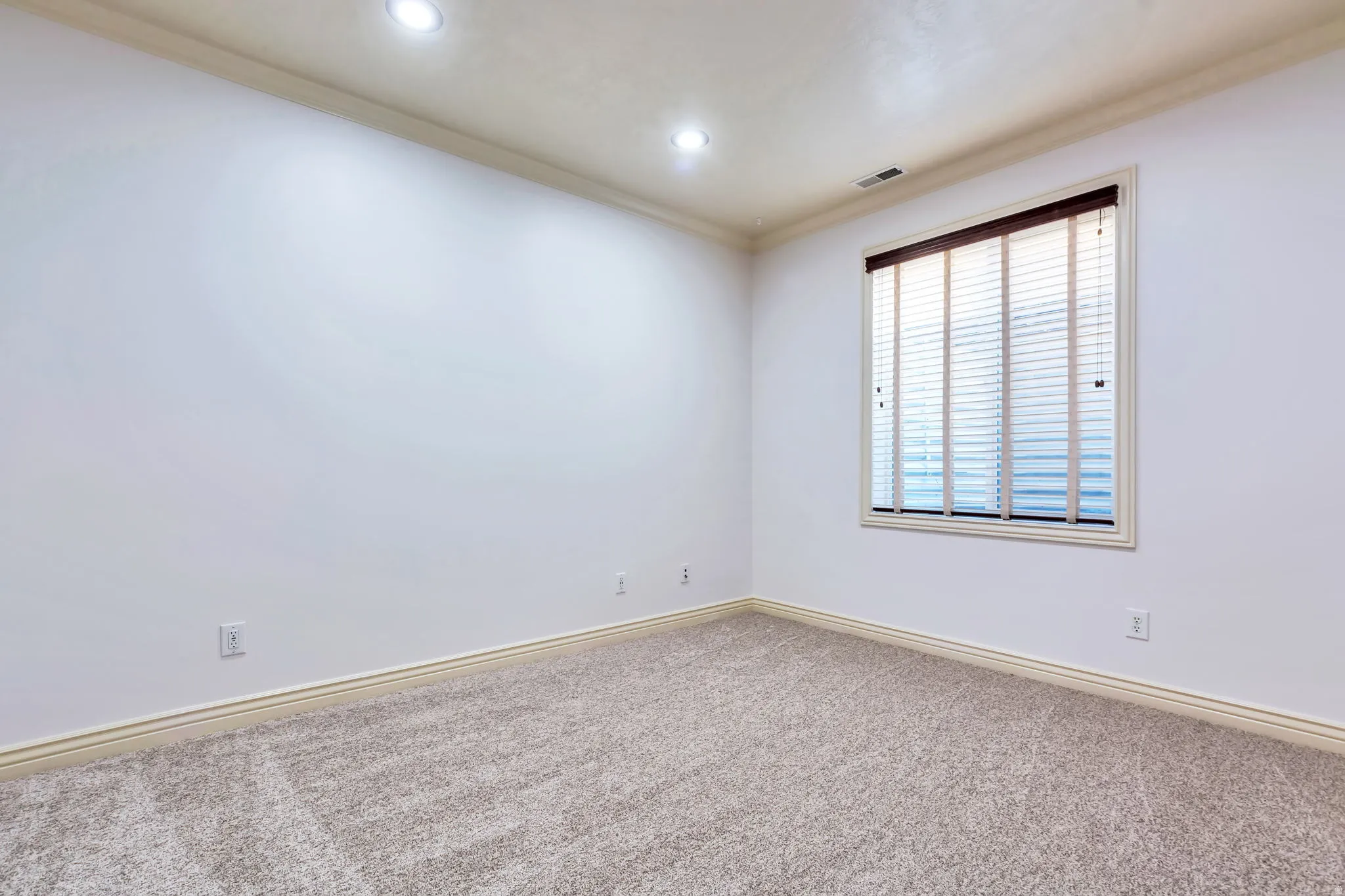 Unfurnished room featuring ornamental molding, carpet, and recessed lighting