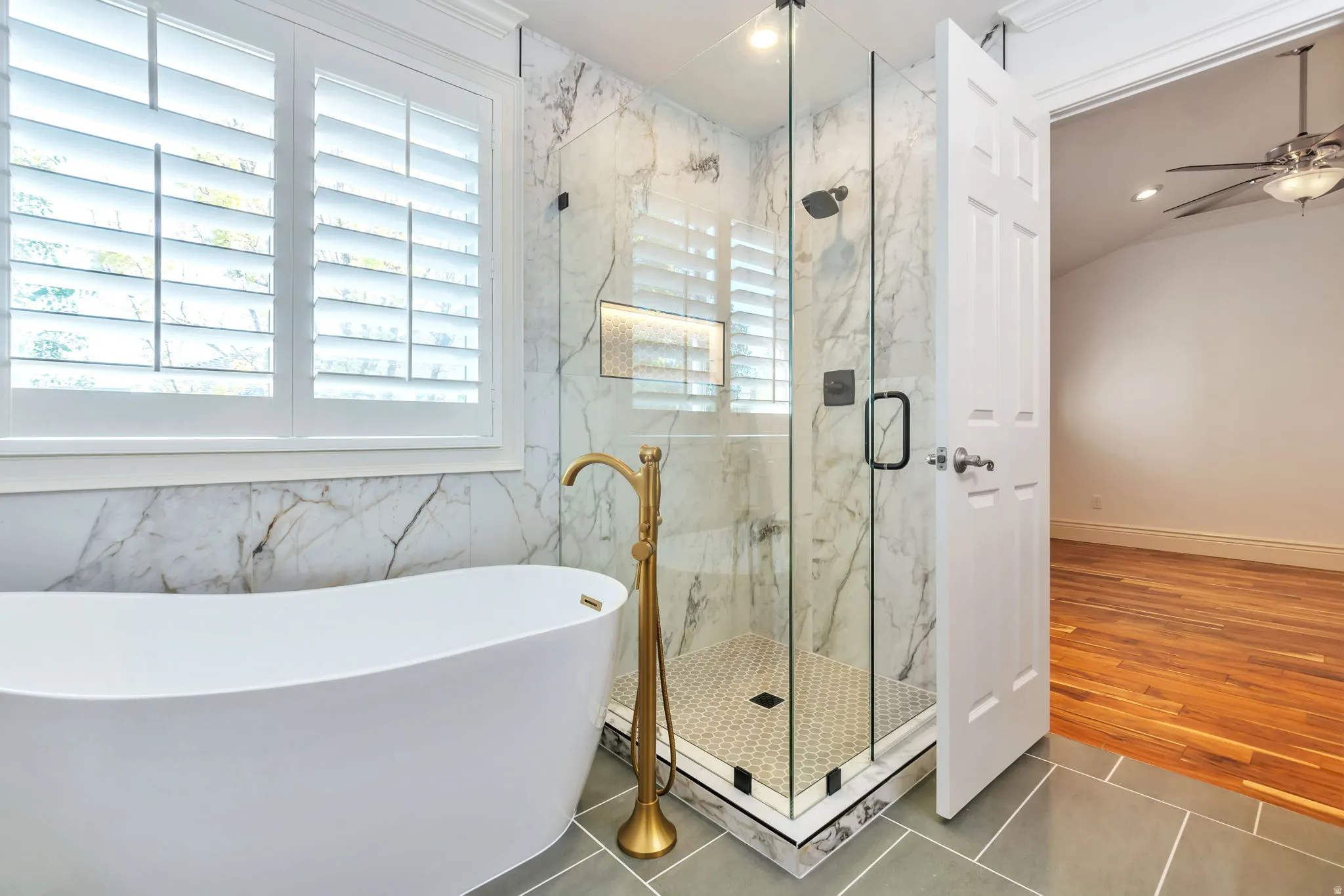 Full bathroom featuring a marble finish shower, a ceiling fan, a freestanding tub, recessed lighting, and tile patterned floors