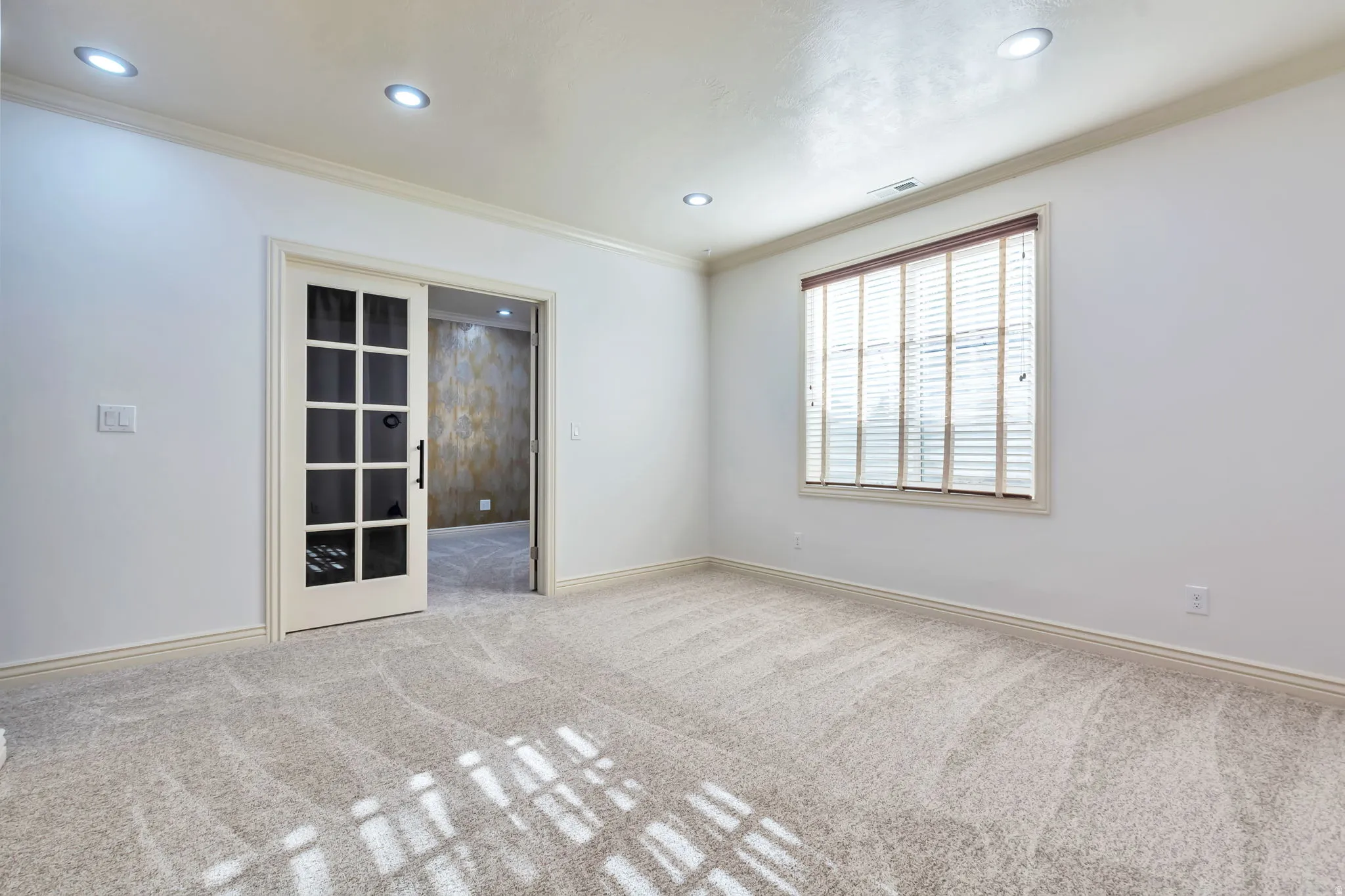 Spare room with crown molding, light colored carpet, and recessed lighting