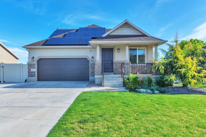 Craftsman inspired home featuring a gate, stucco siding, solar panels, concrete driveway, and a porch