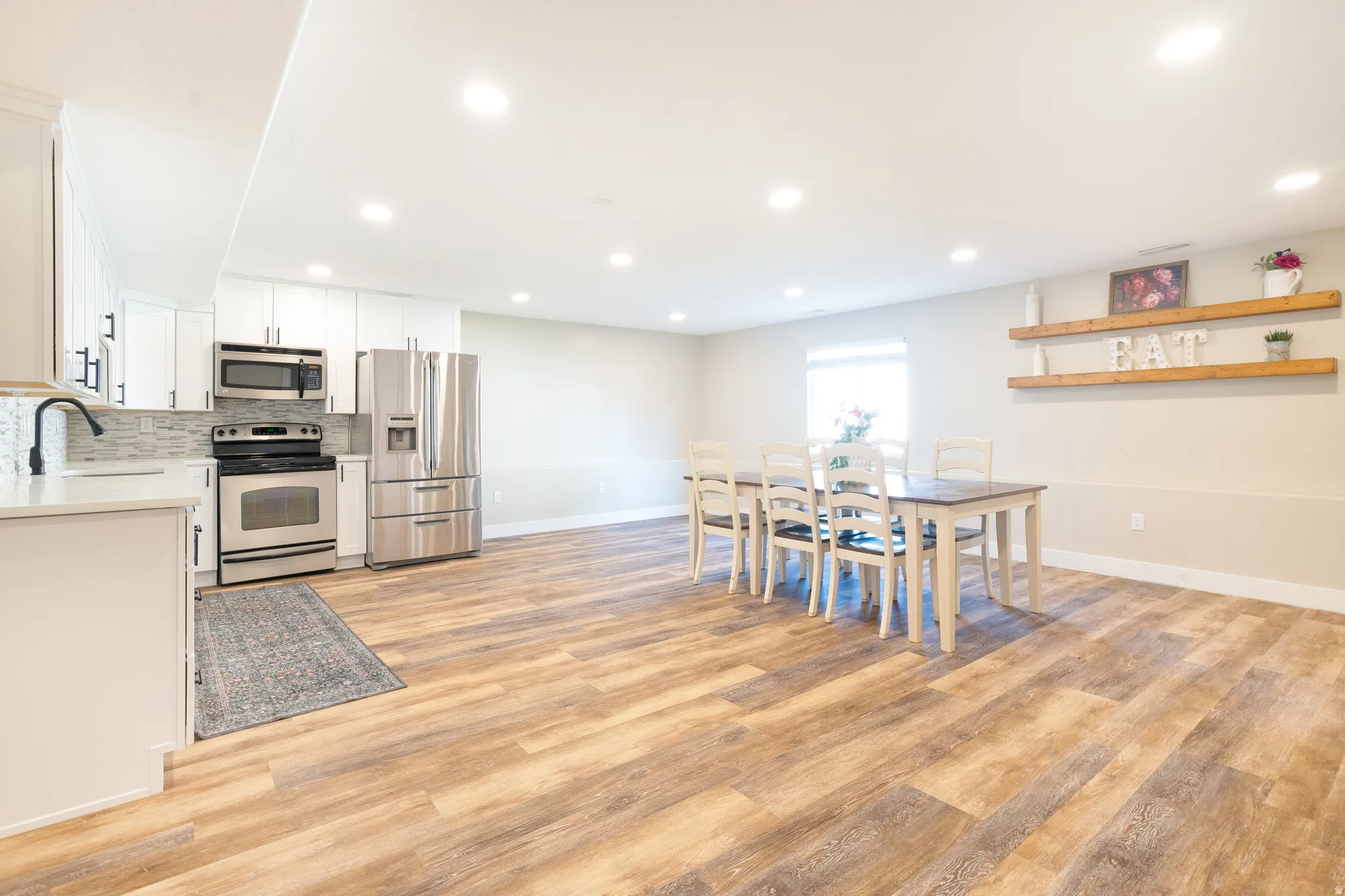 Dining space featuring light wood-style flooring and recessed lighting