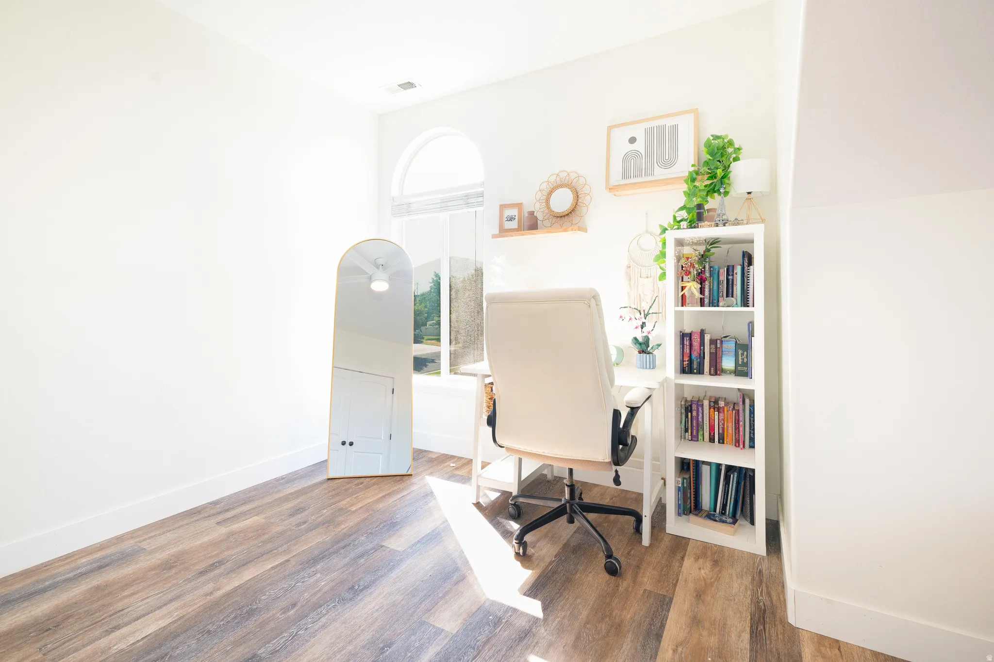 Office space featuring dark wood finished floors and baseboards