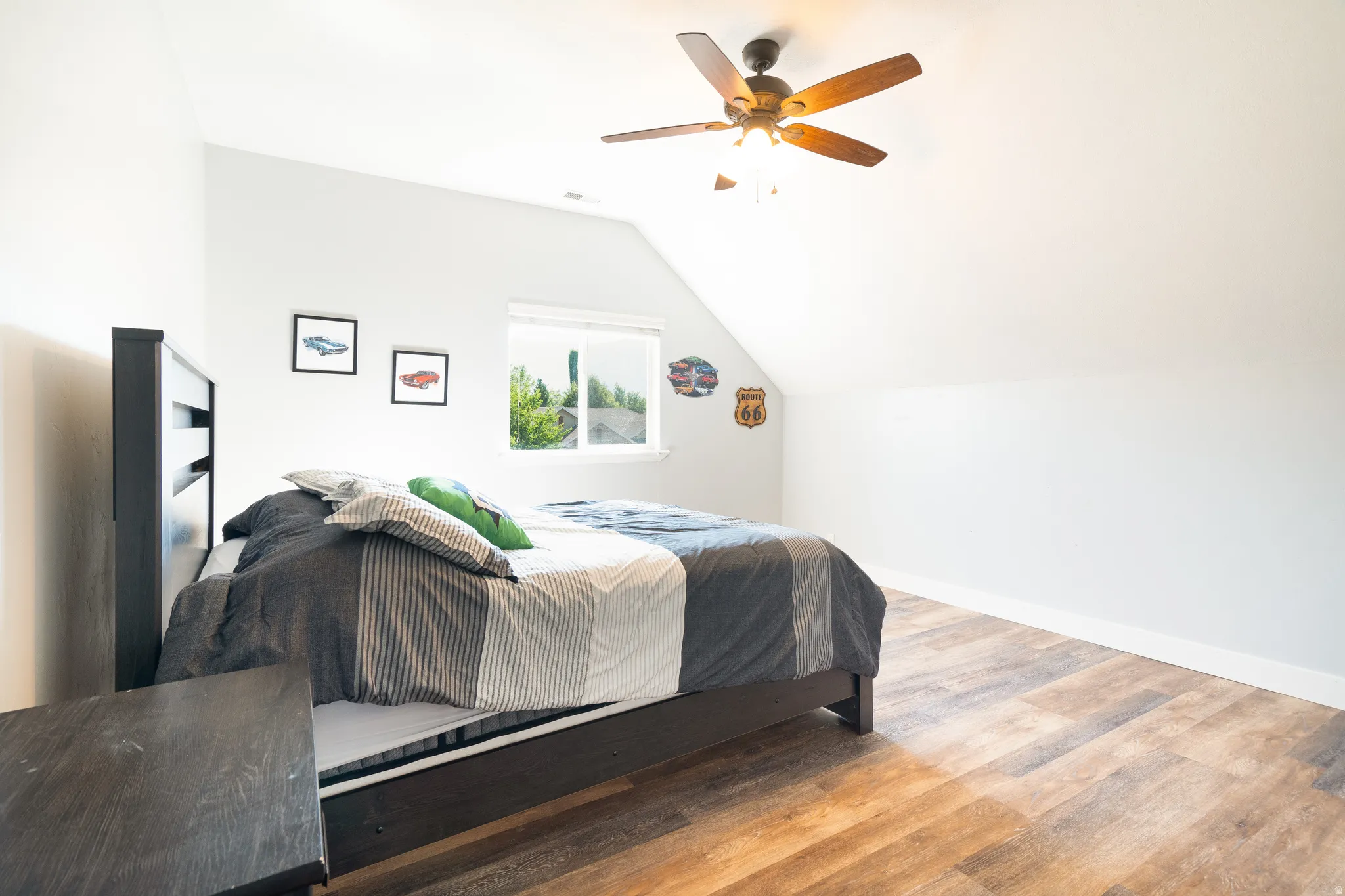Bedroom featuring light wood-style flooring, ceiling fan, and lofted ceiling