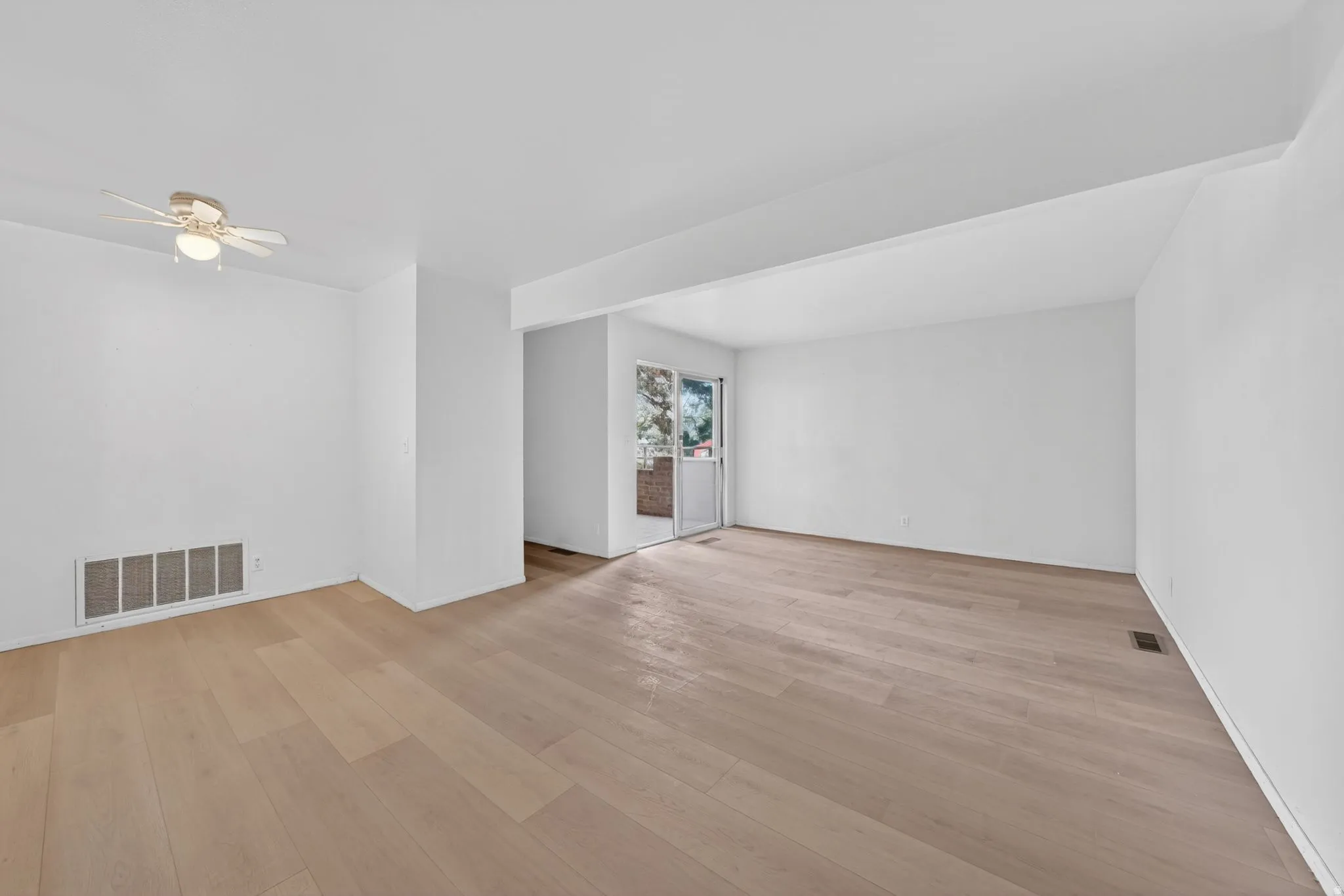 Unfurnished room with a ceiling fan and light wood finished floors