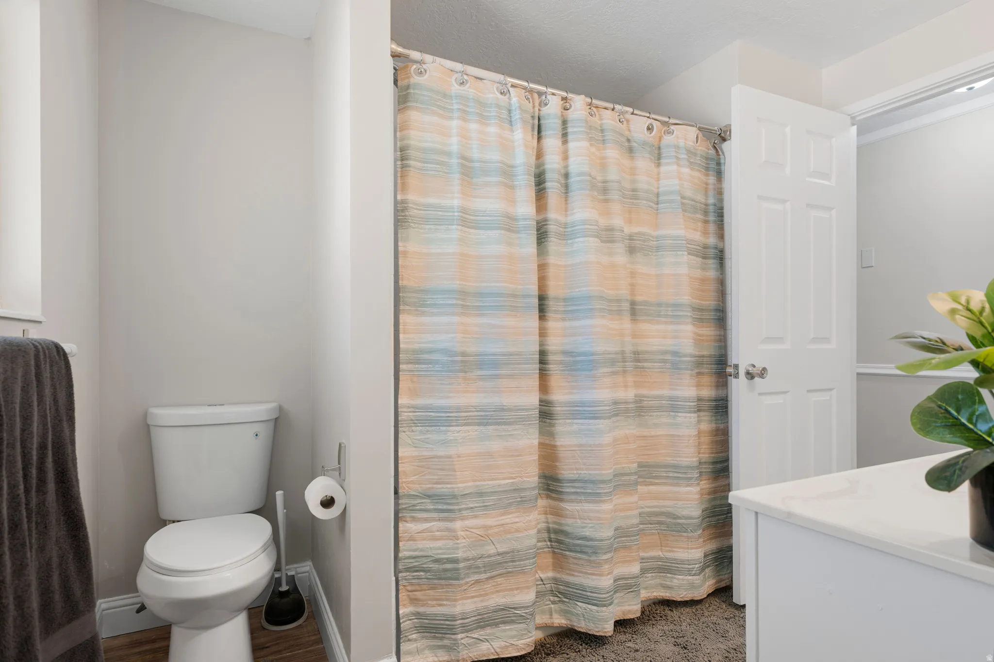 Bathroom featuring curtained shower and vanity