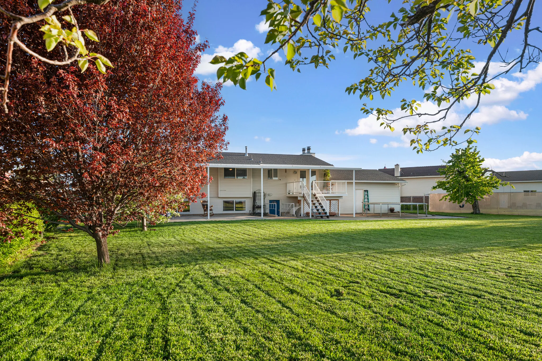 Back of property featuring stairs and a patio