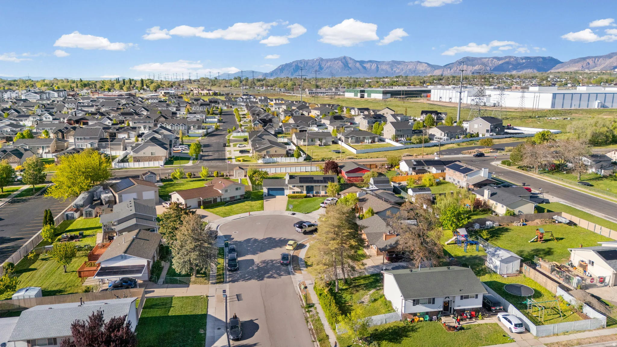 Aerial perspective of suburban area with a mountainous background