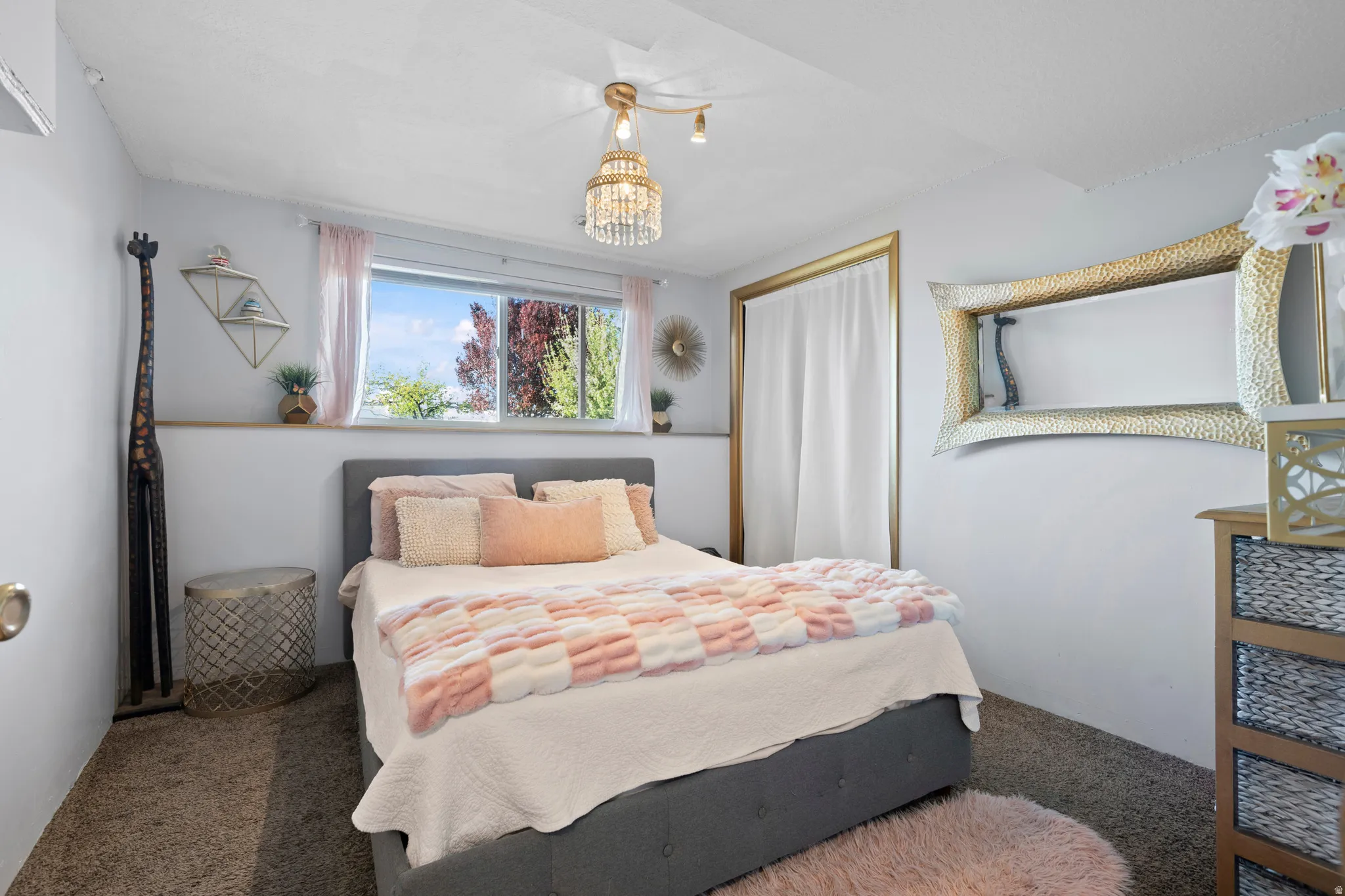 Bedroom featuring carpet floors and hanging lights