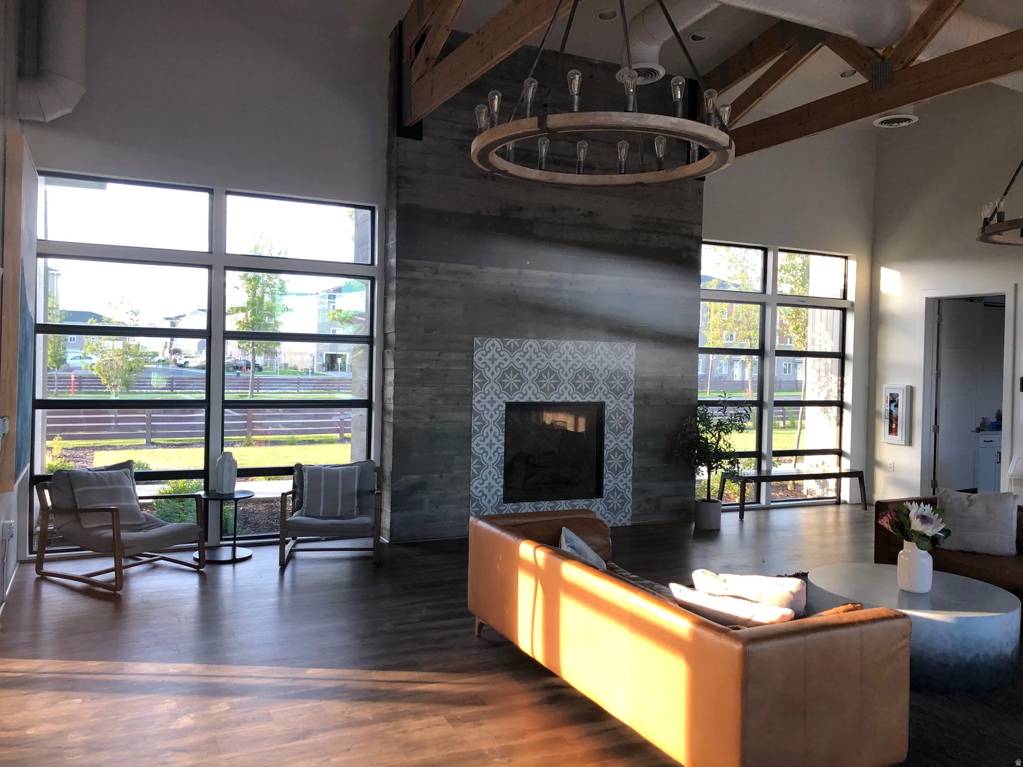 Living room featuring a fireplace, wood finished floors, and vaulted ceiling