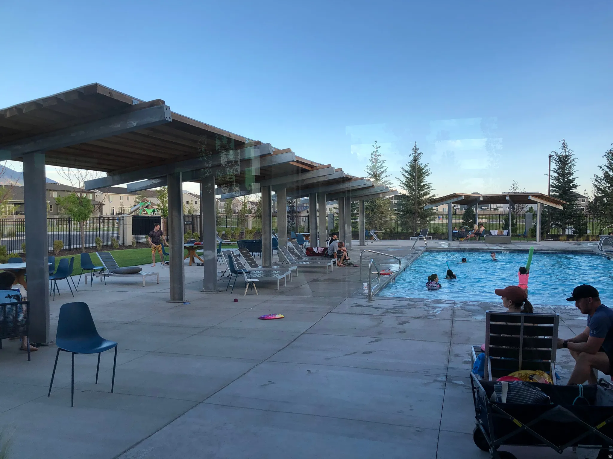 Community pool with a patio