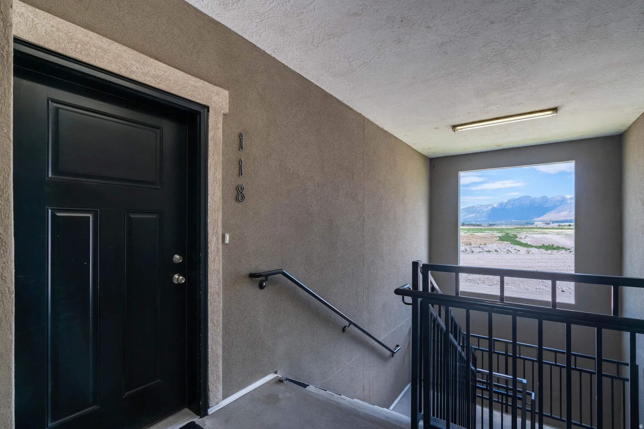 Property entrance with stucco siding and a mountain view