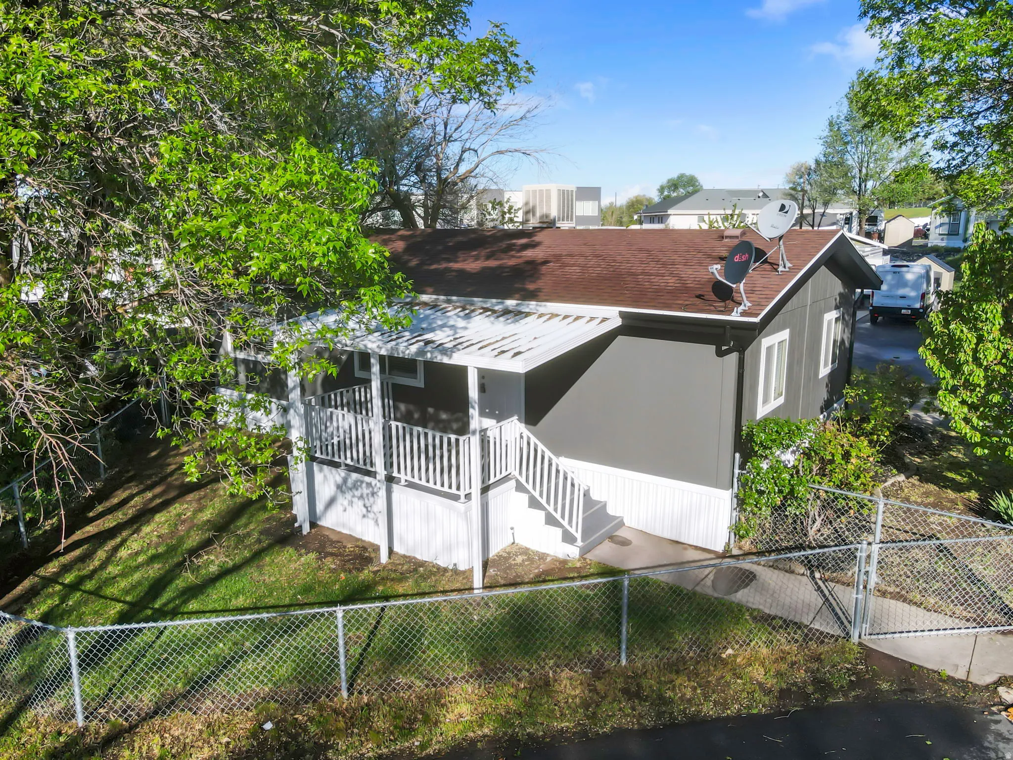 Back of house featuring a fenced front yard and a gate