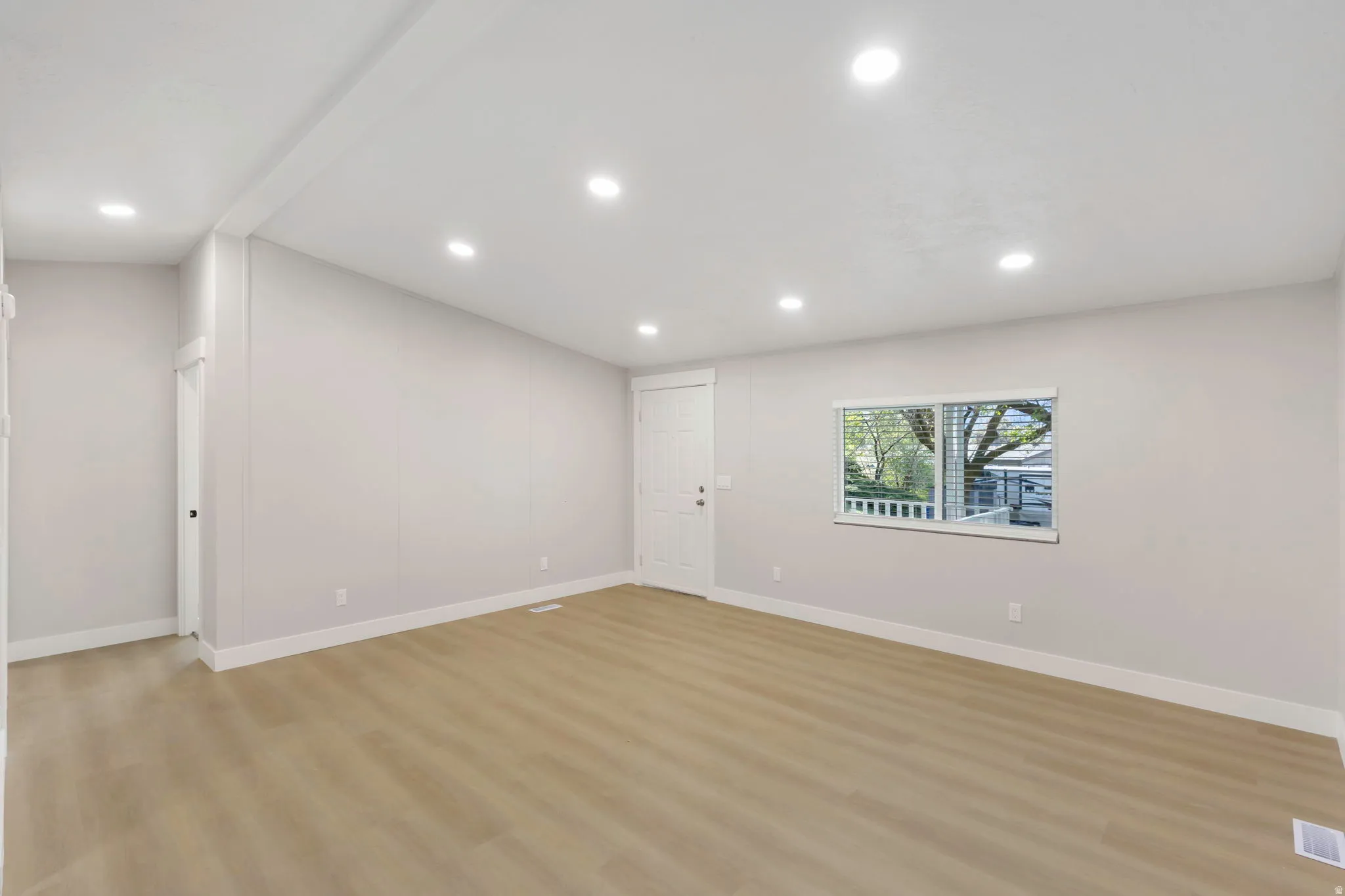 Basement featuring light wood-style flooring and recessed lighting