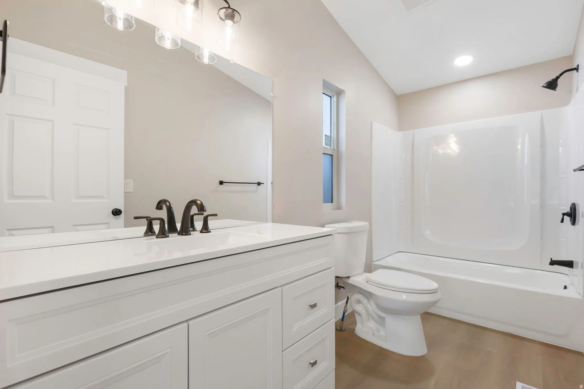 Full bath featuring vanity, tub / shower combination, and light wood-type flooring