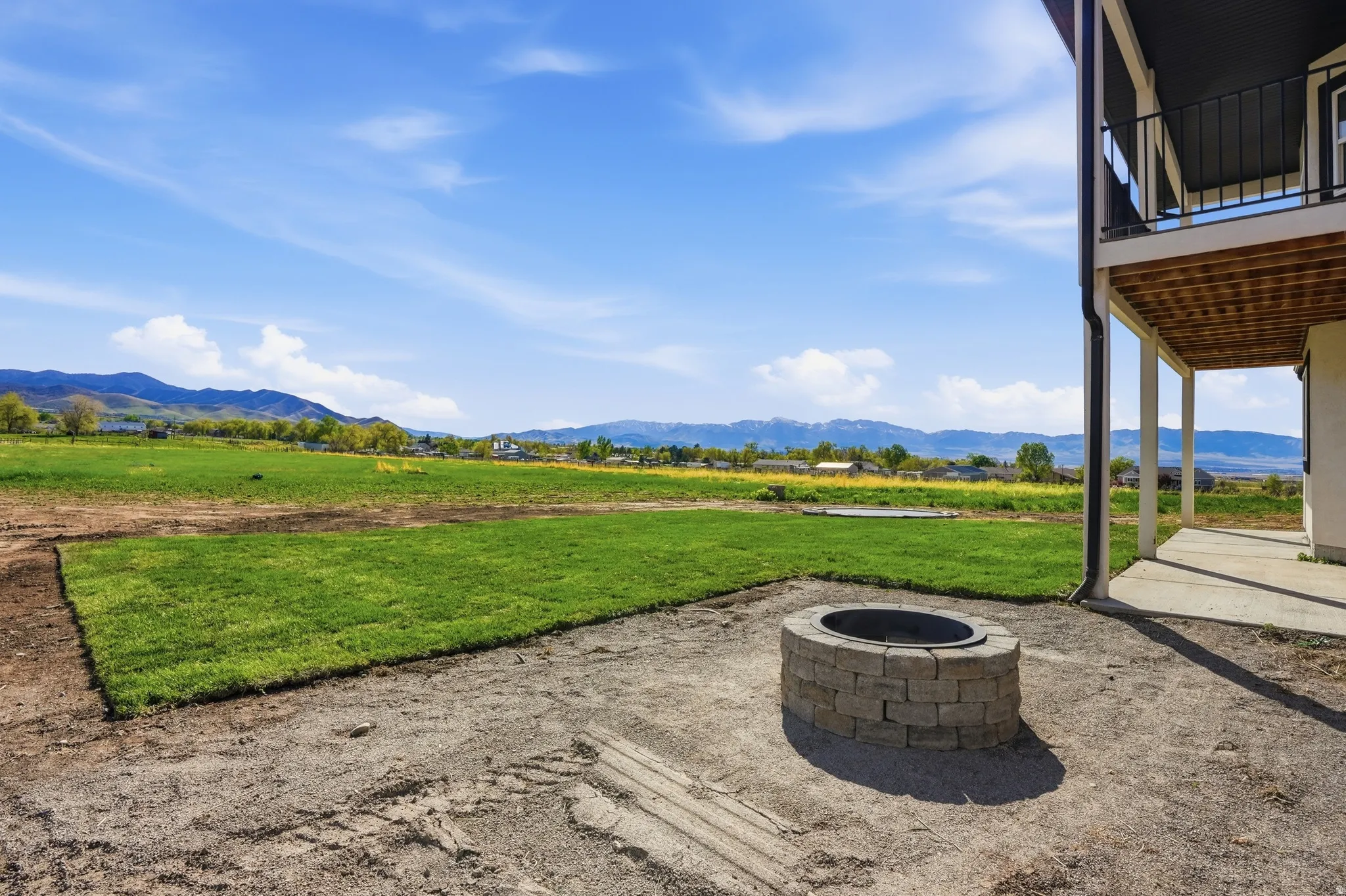 View of patio with a mountain view and an outdoor fire pit