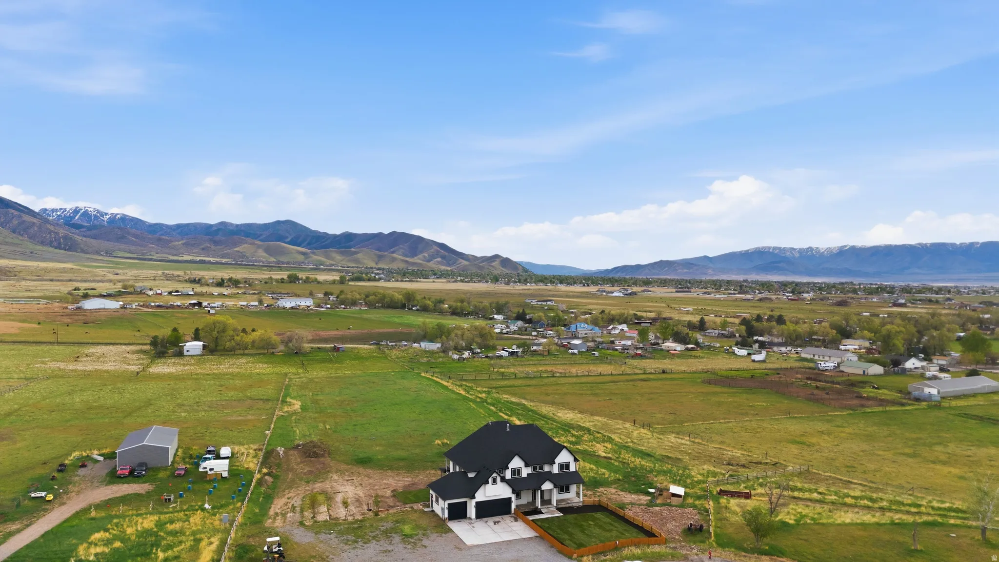 Overview of rural landscape featuring a mountain backdrop and agricultural land