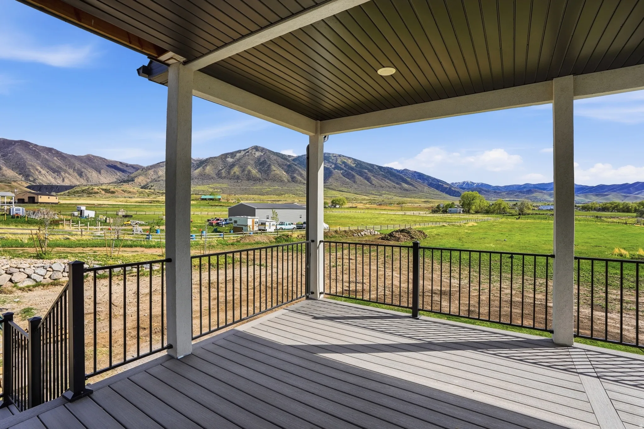 South West Facing View! Wooden terrace featuring a view of rural / pastoral area and a mountain view