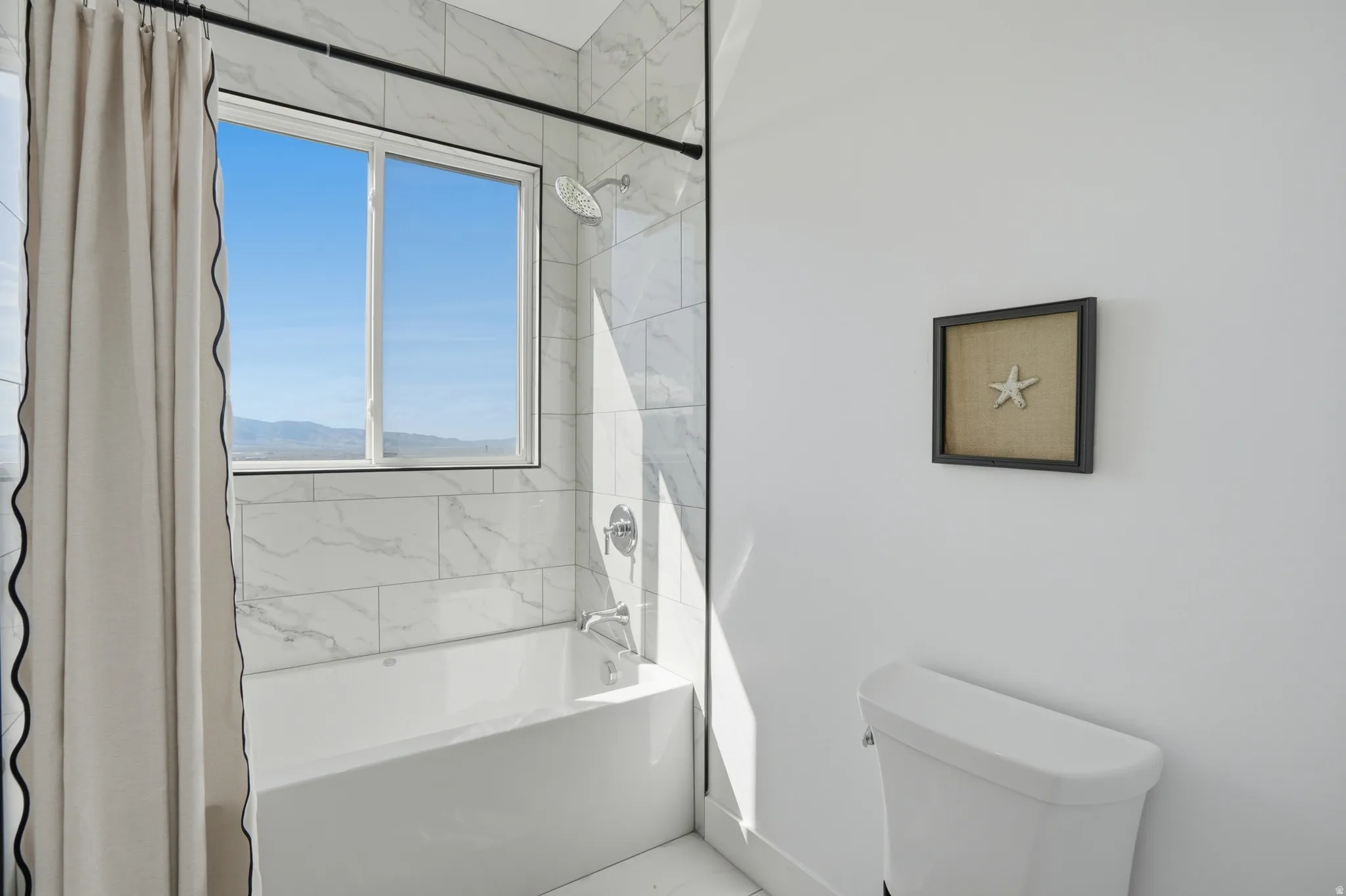 From Jack and Jill, Full bathroom featuring toilet and shower / bath combo with shower curtain