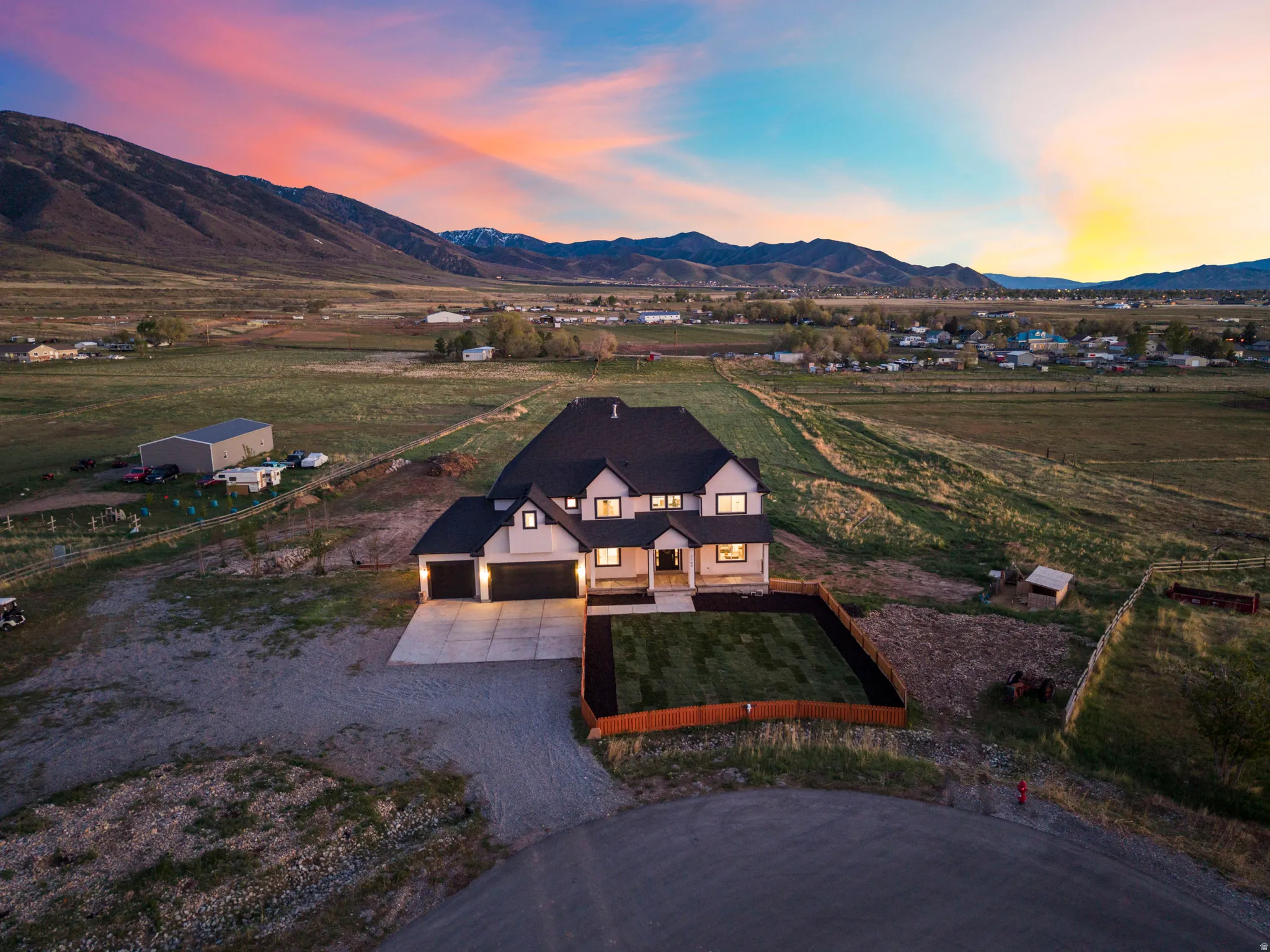 Aerial view of sparsely populated area with mountains and agricultural land