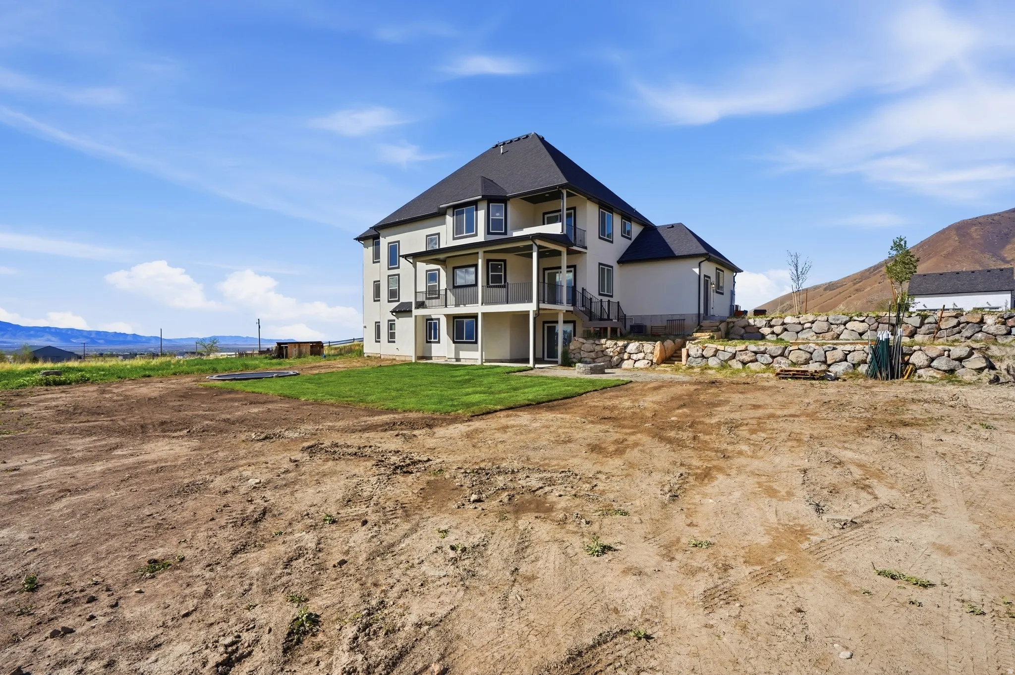 Rear view of house with a mountain view and stucco siding