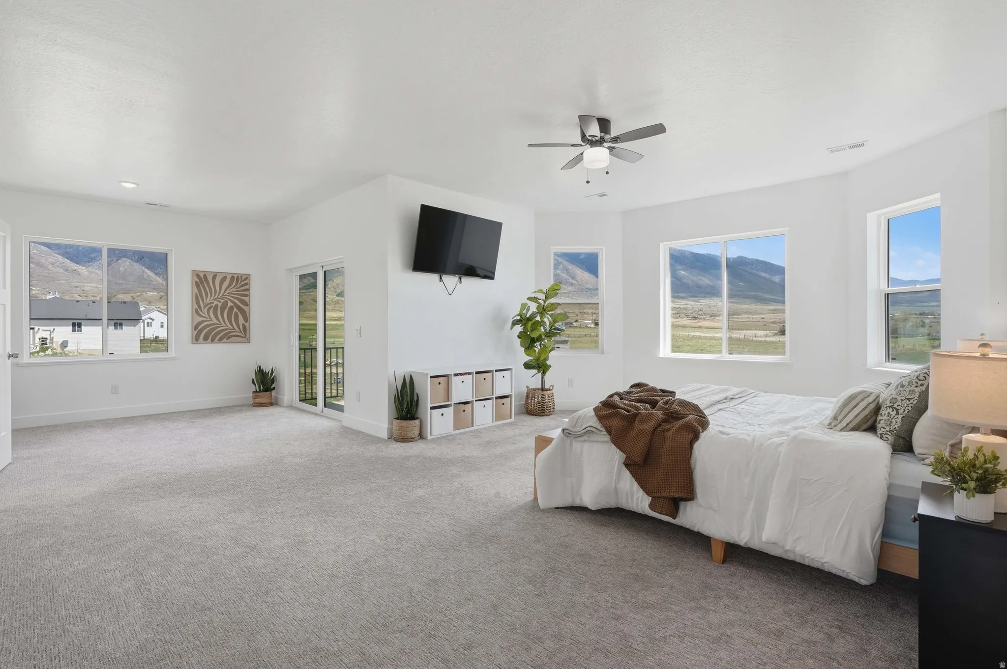 Master Bedroom Carpeted bedroom with access to outside and ceiling fan