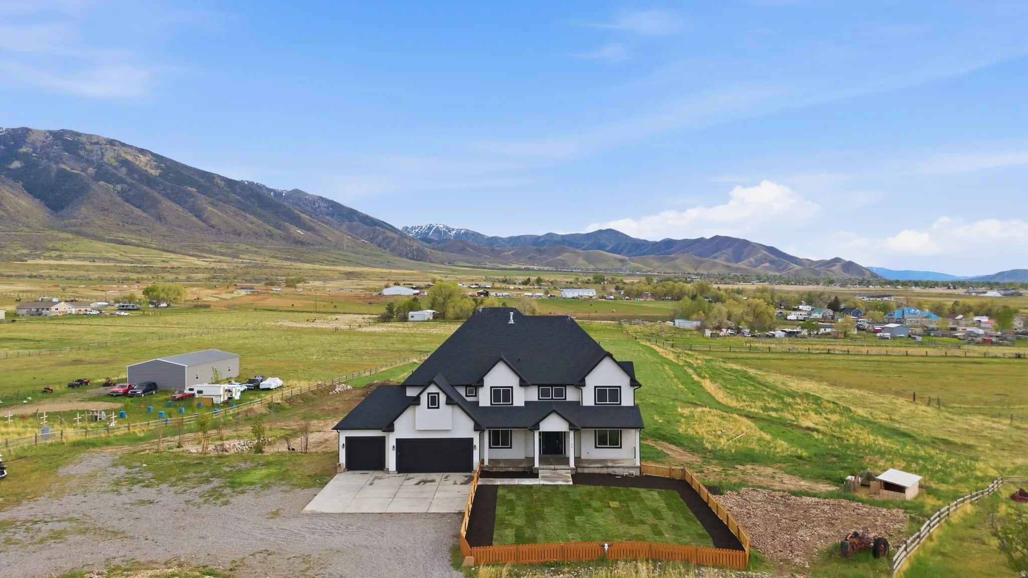 Overview of rural landscape featuring a mountain backdrop and agricultural land