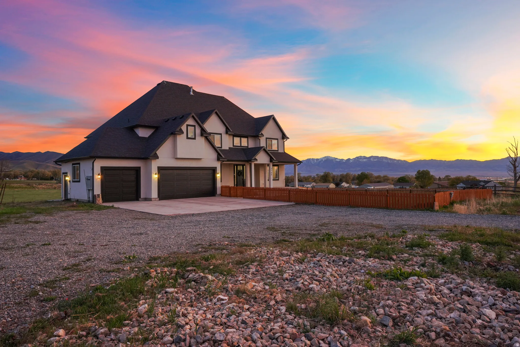 Modern inspired farmhouse with a mountain view, driveway, and a garage