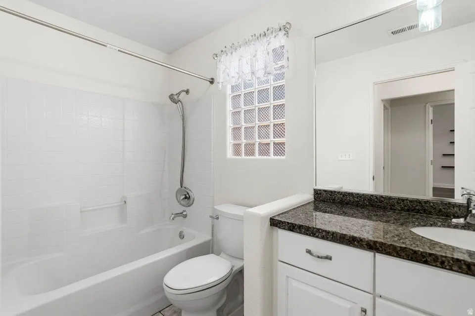 Full bath with vanity and tub / shower combination