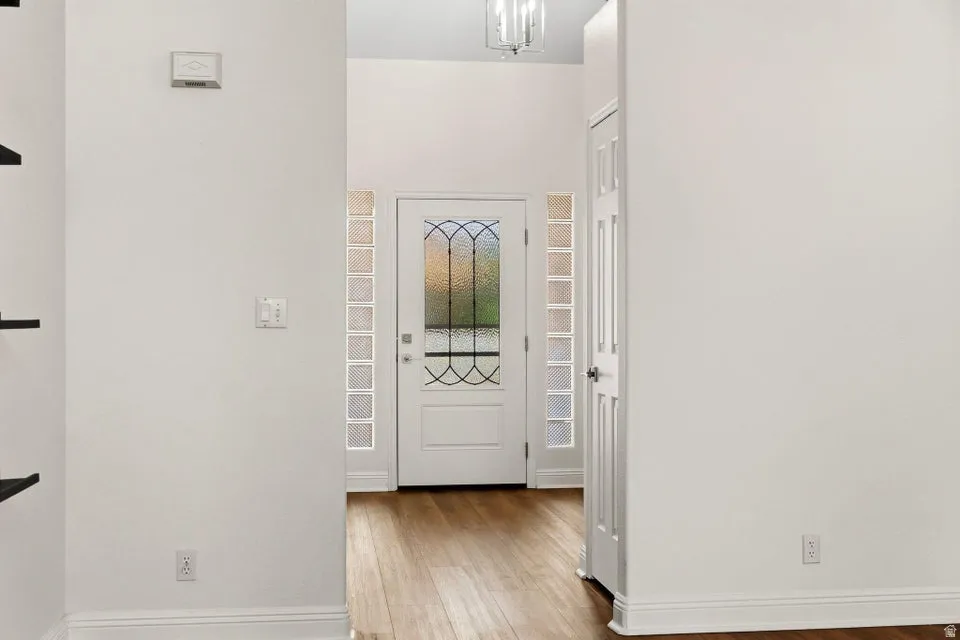 Foyer featuring baseboards and light wood finished floors
