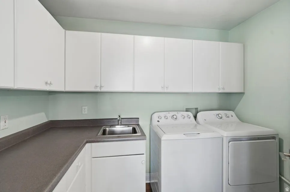 Laundry area with cabinet space and washing machine and clothes dryer