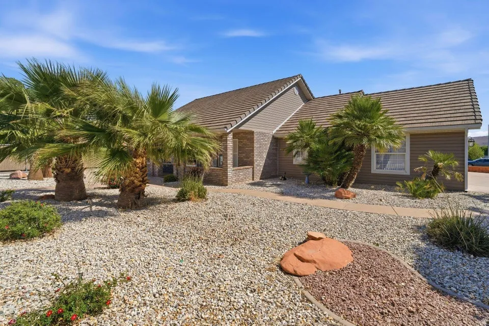 View of front of home with a tiled roof and brick siding