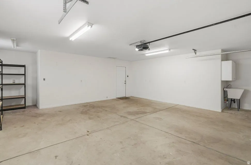 Garage with a sink and a garage door opener