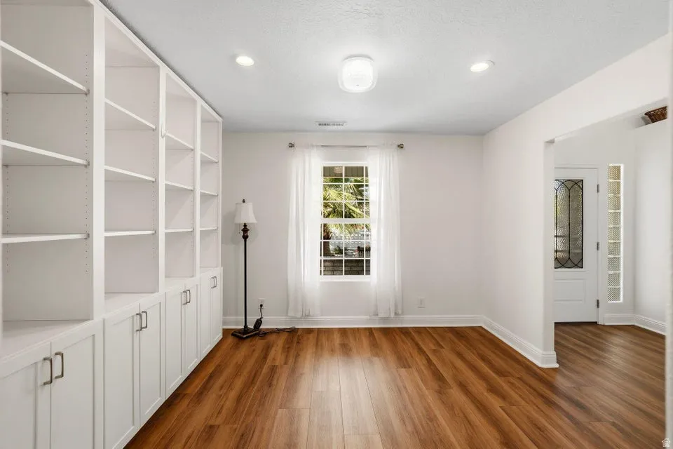 Spare room featuring dark wood finished floors and recessed lighting