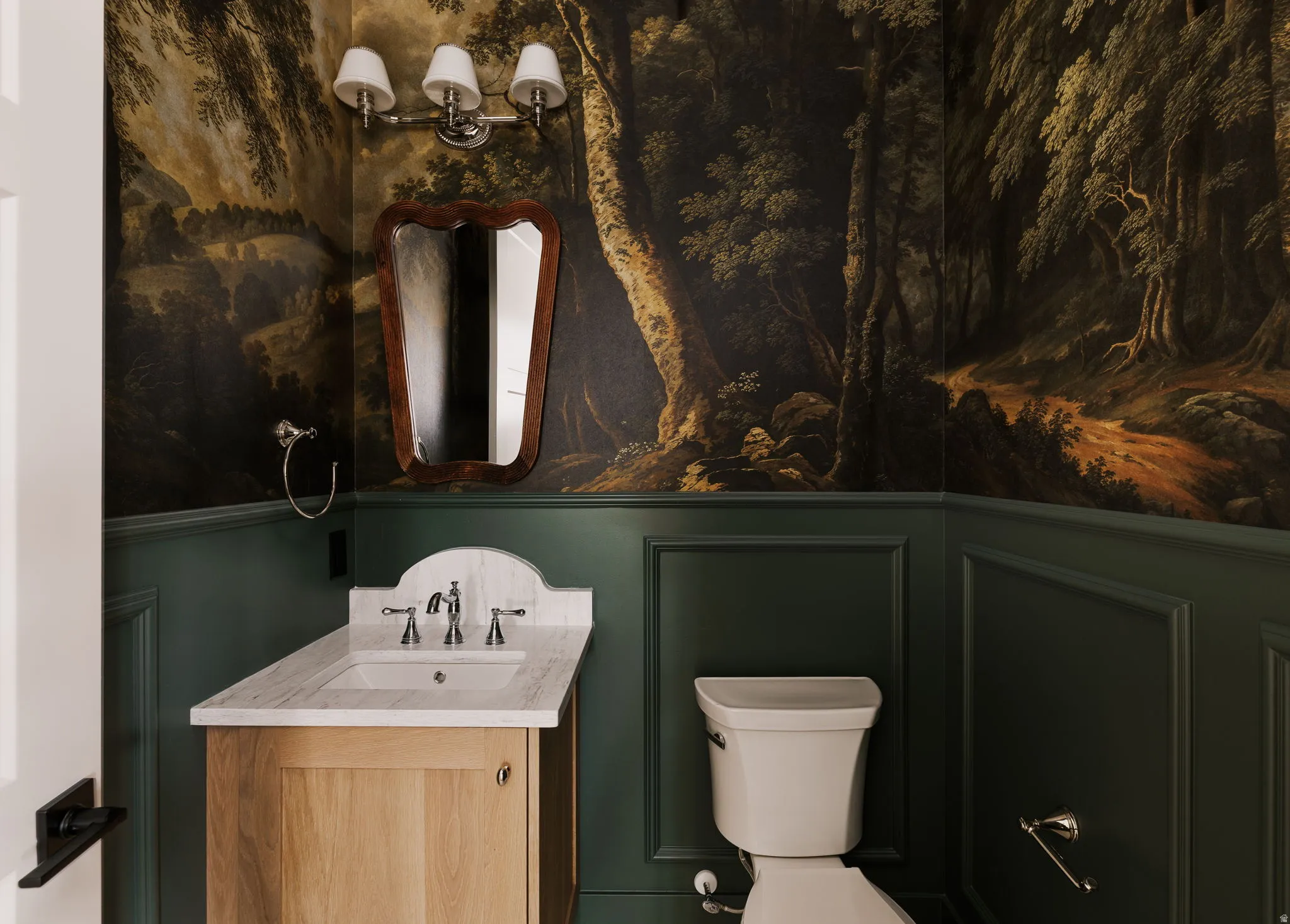 Powder Bathroom featuring vanity and a decorative wall