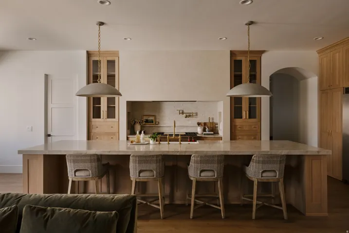 Kitchen with a breakfast bar area, glass insert cabinets, dark wood finished floors, and recessed lighting