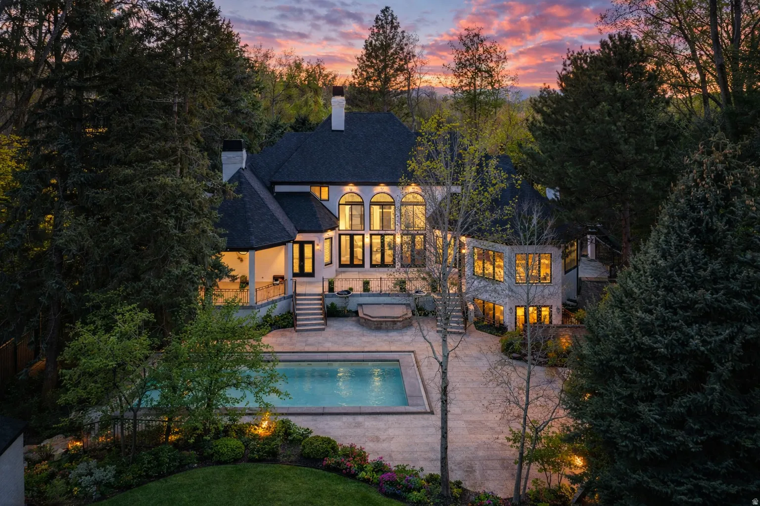 Back of house with a spa, pool, huge .91ac yard, decks and patios, in ground trampoline, basketball court and more!