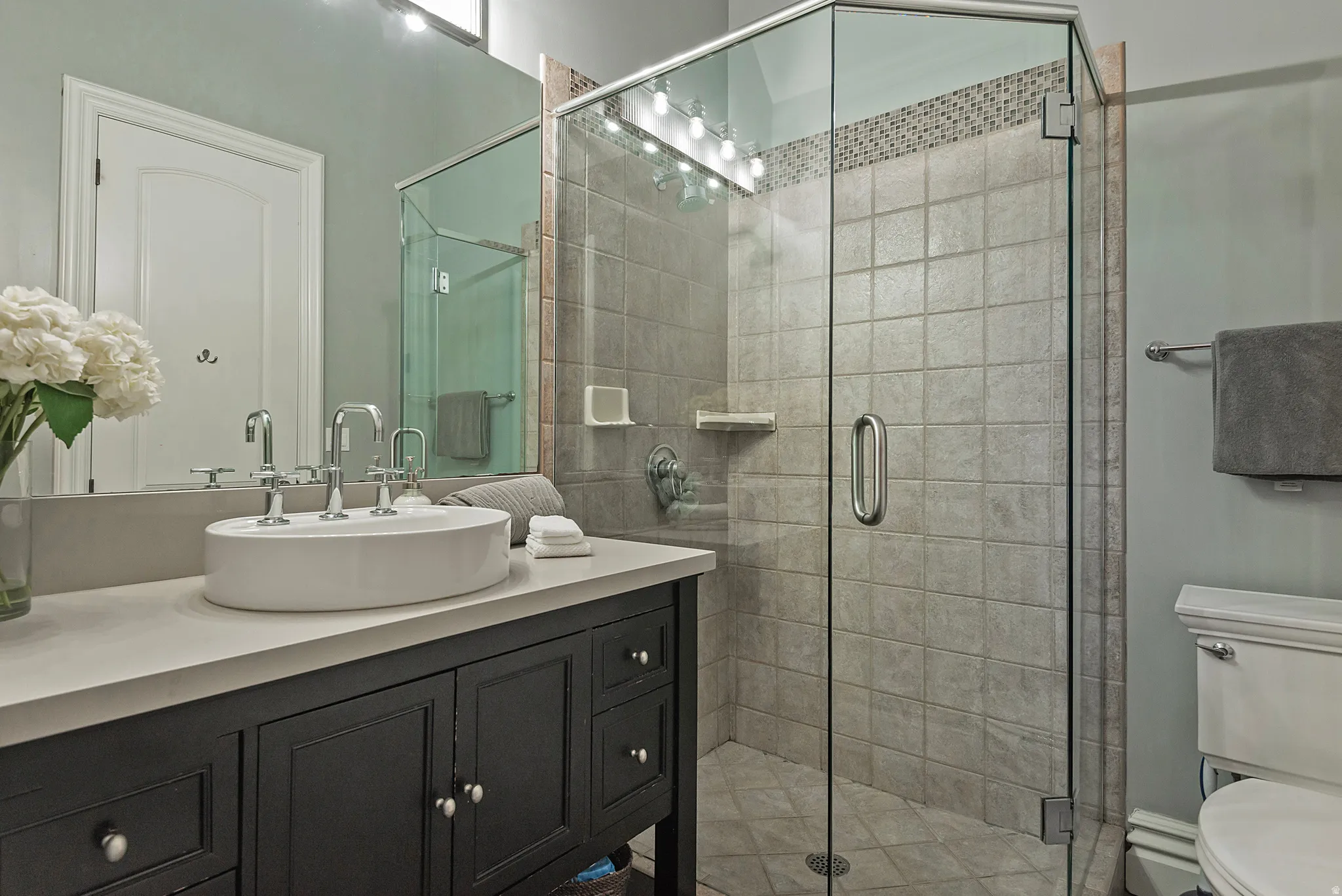 Bathroom featuring vanity and a stall shower