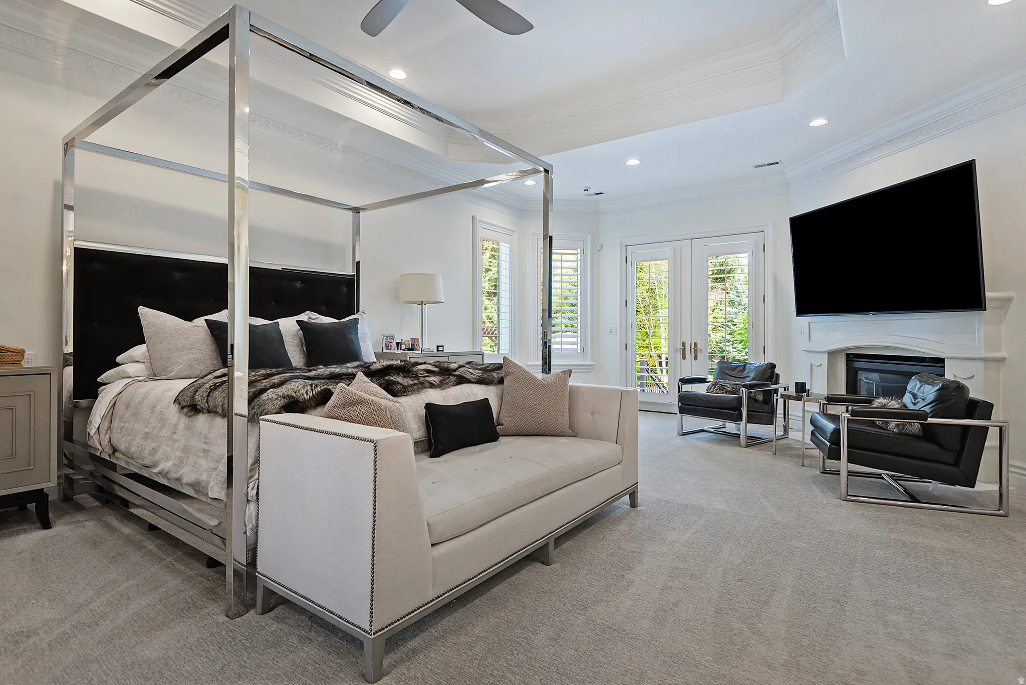 Main floor spacious primary suite with gas fireplace, and walkout to private patio