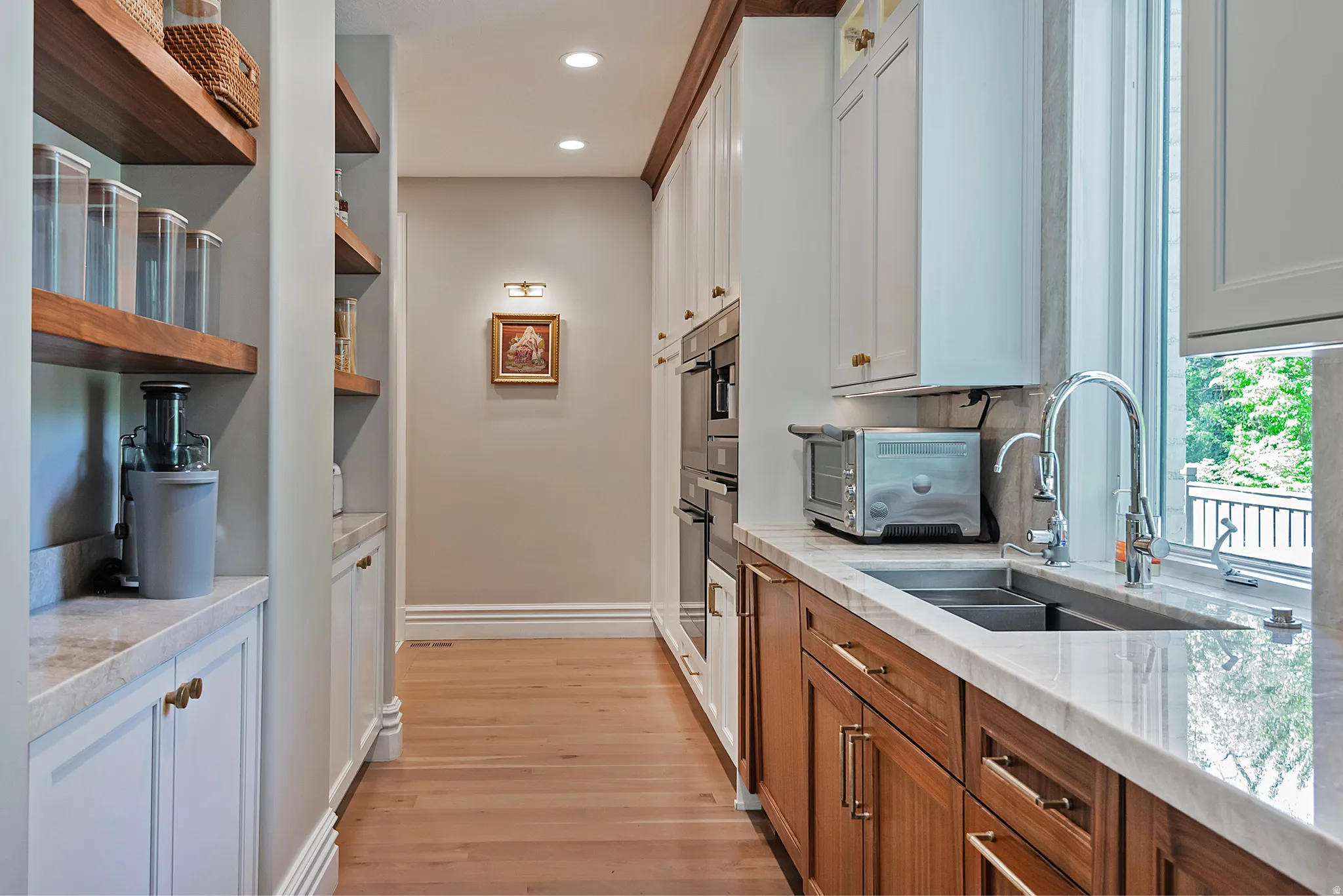 Extra sink and ovens in open and light pantry area